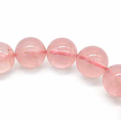 Deep pink Mozambique rose quartz held to the light