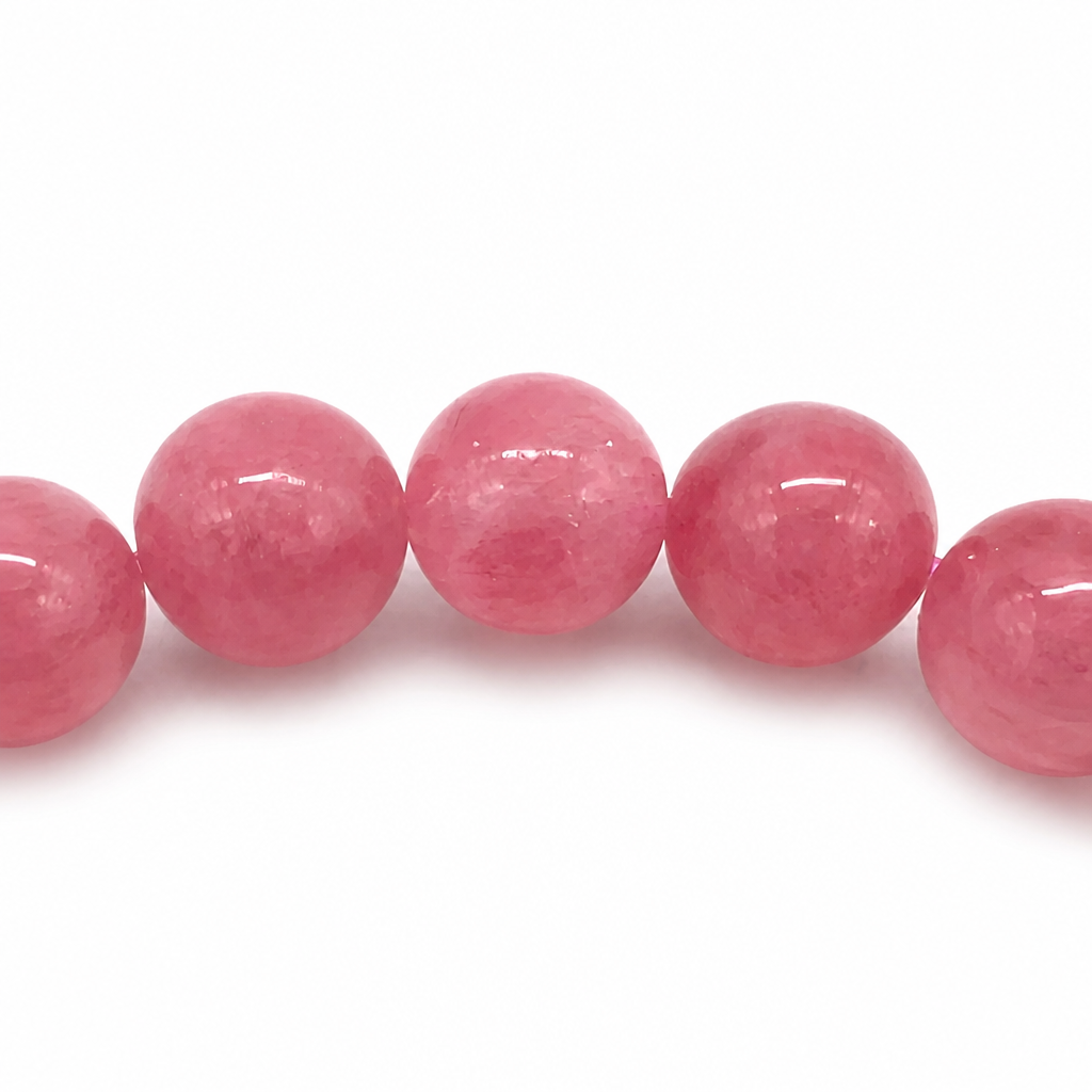 Bold pink-and-black rhodonite beads catching the light