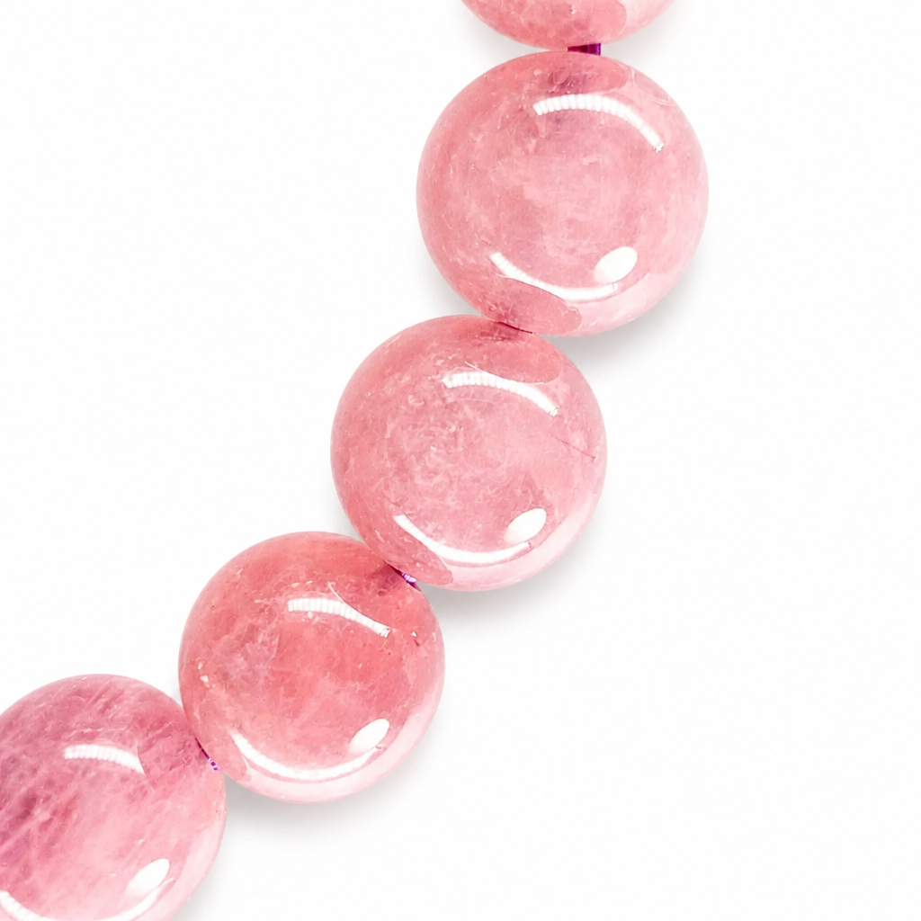 Detail of a rutile asterism star drifting across a rose quartz bead